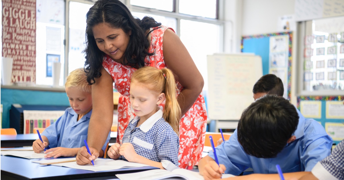 Teacher helping students